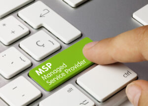 Image of a finger pressing a key on a keyboard that is labeled MSP Manages Service Provider