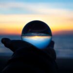 hand holding a glass sphere